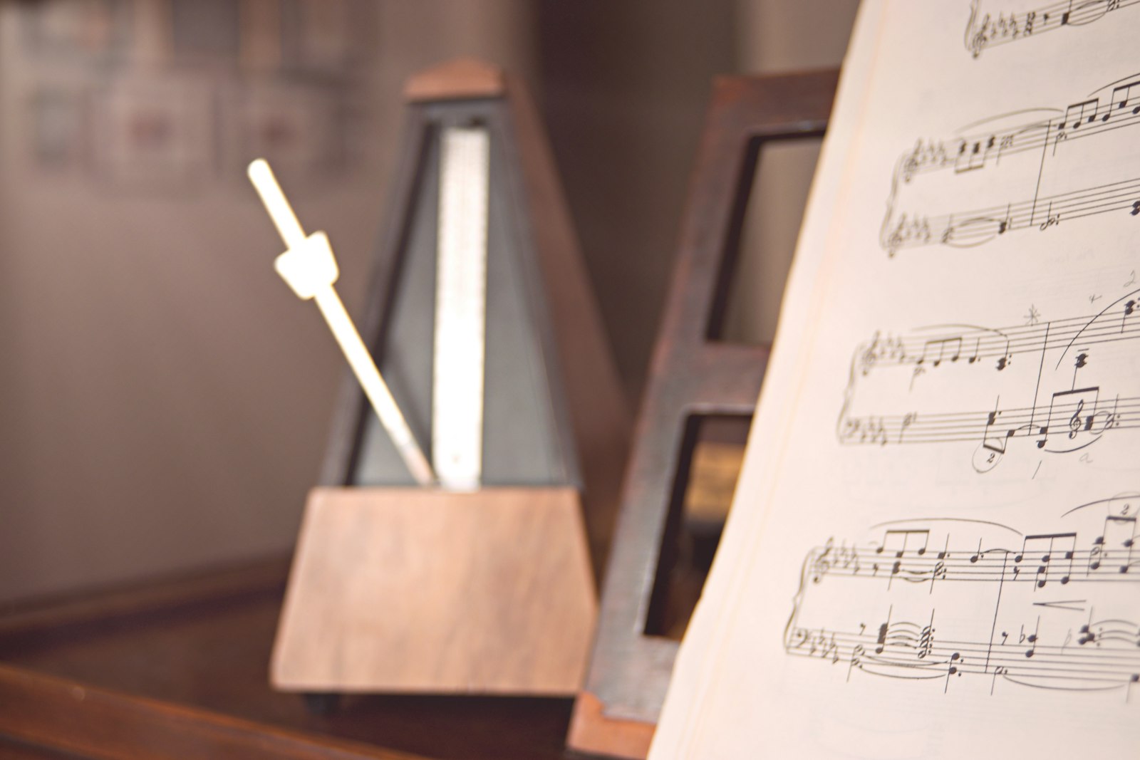 Sheet music and a metronome on a wooden table